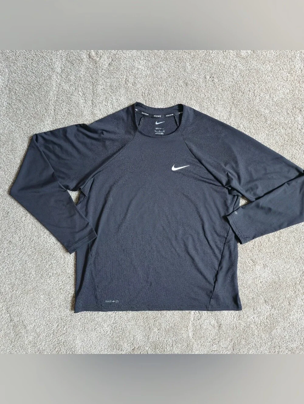 Nike Swim Dri-FIT long-sleeve Rashguard features a classic athletic crewneck